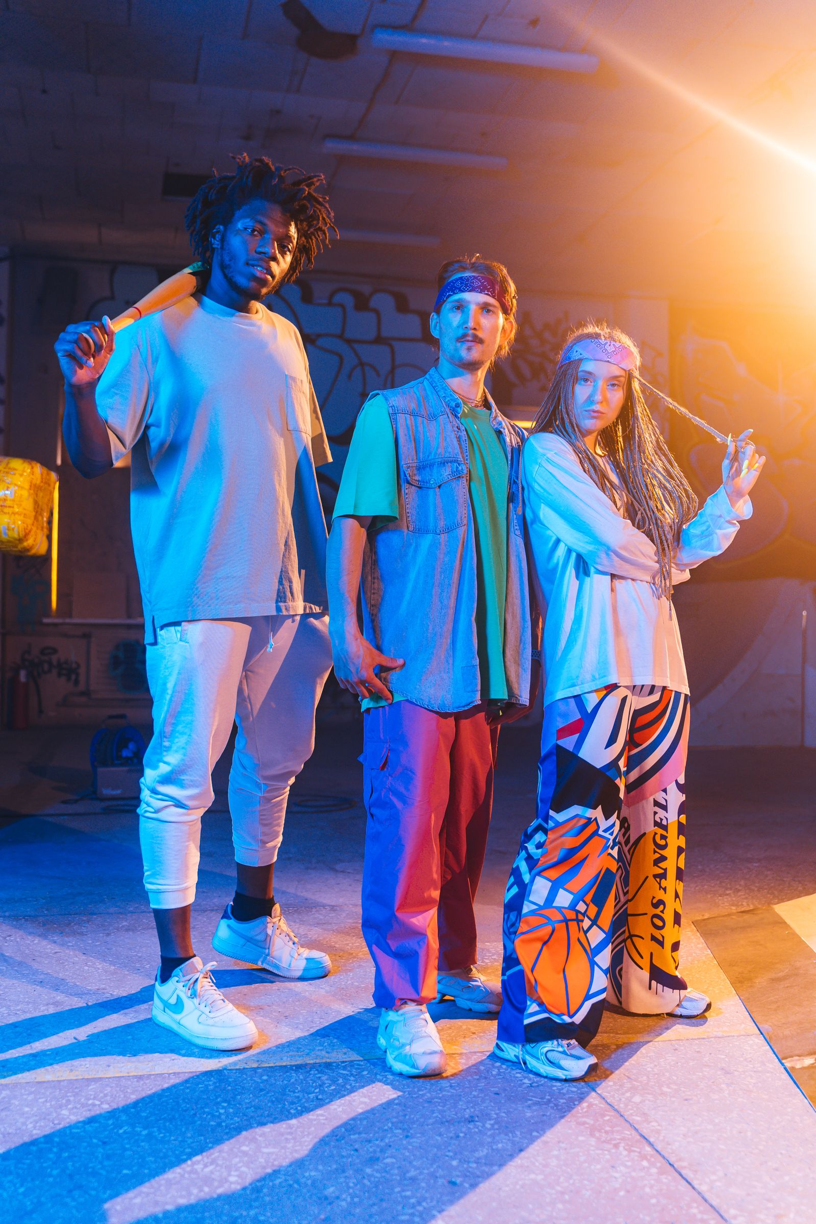 Trio of dancers lit in blue and orange neon