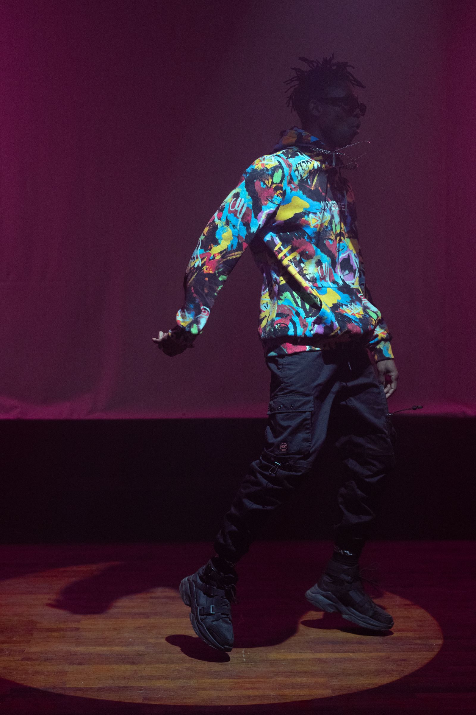 Breaker holding a one-handed handstand beside a reflection