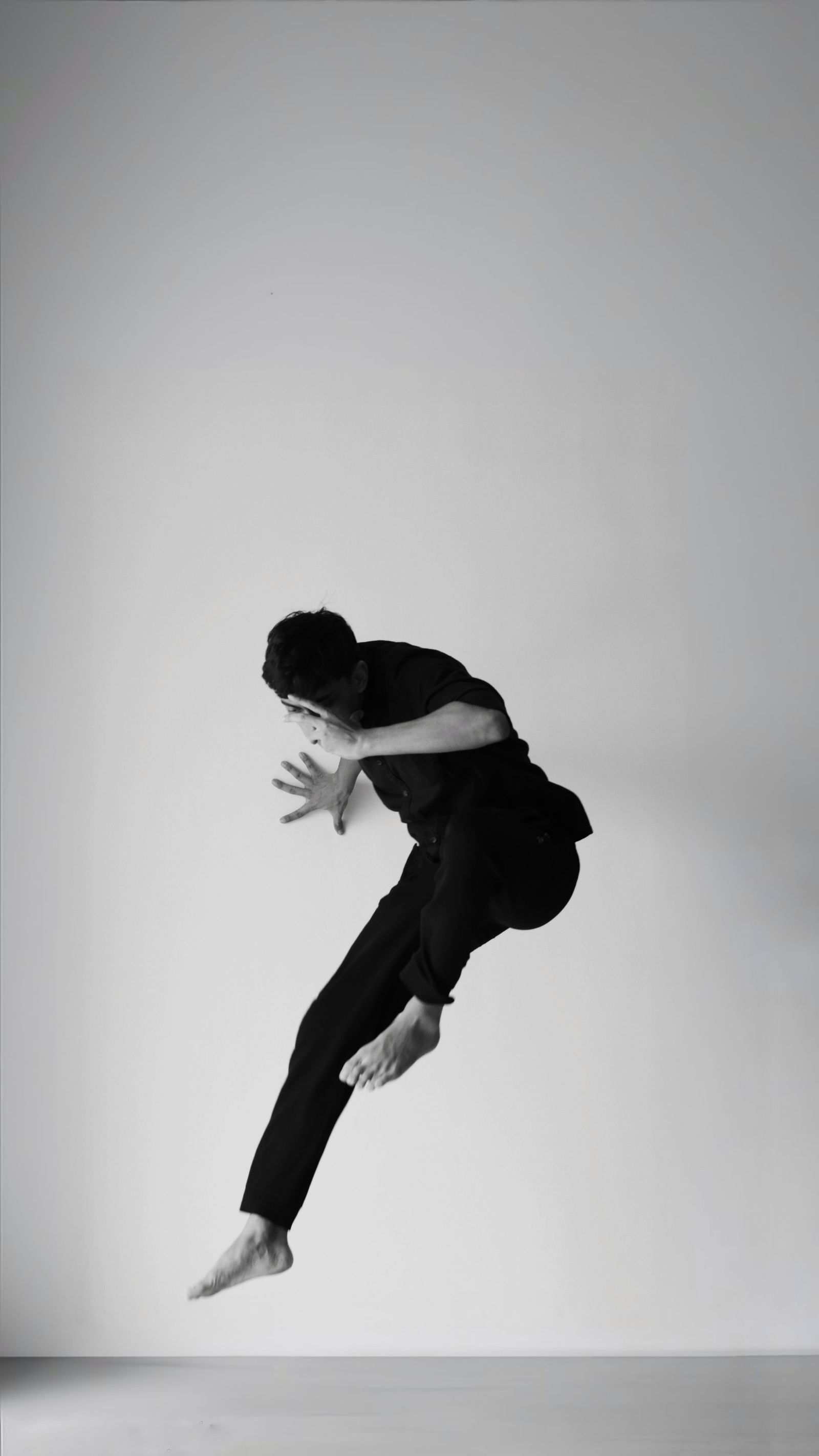 Black and white photo of a dancer suspended mid-jump