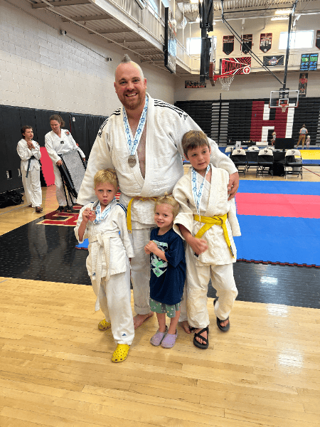Mr. Owen Yurko with young judo students after a tournament