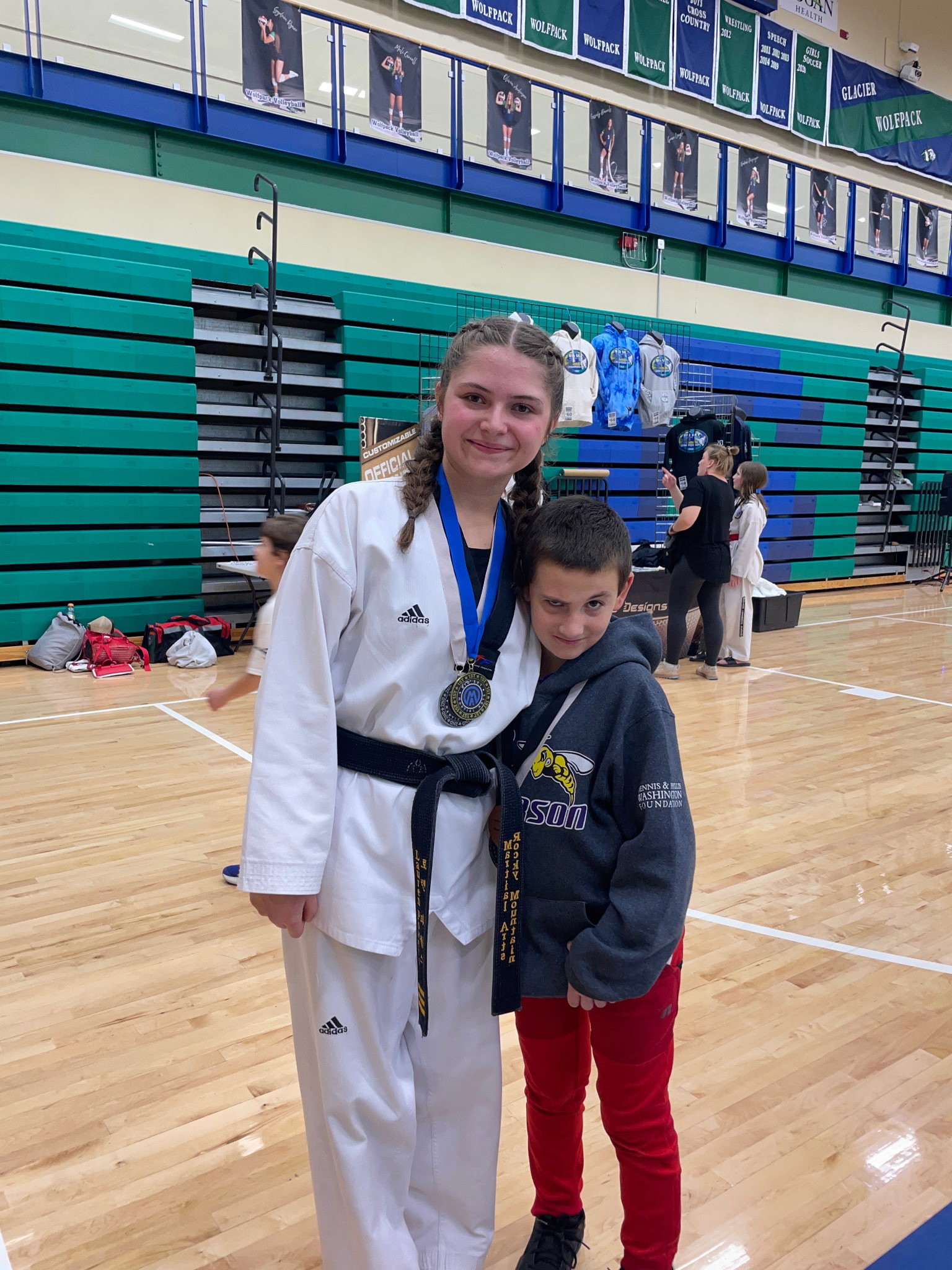 Miss Lauren Powers in her dobok with a medal at a taekwondo tournament
