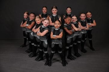 Be Famous Dance Center students in black and silver costumes